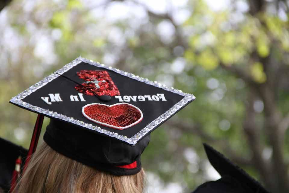 A graduate wears a decorated graduation cap