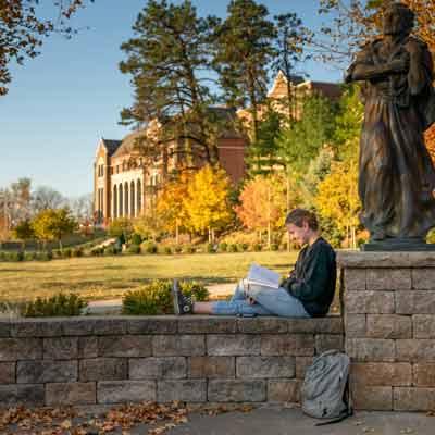 A student reading on campus