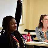 A BCYC Immersion participant raises her hand in class