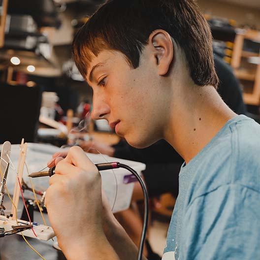 BCYC student soldering a wire